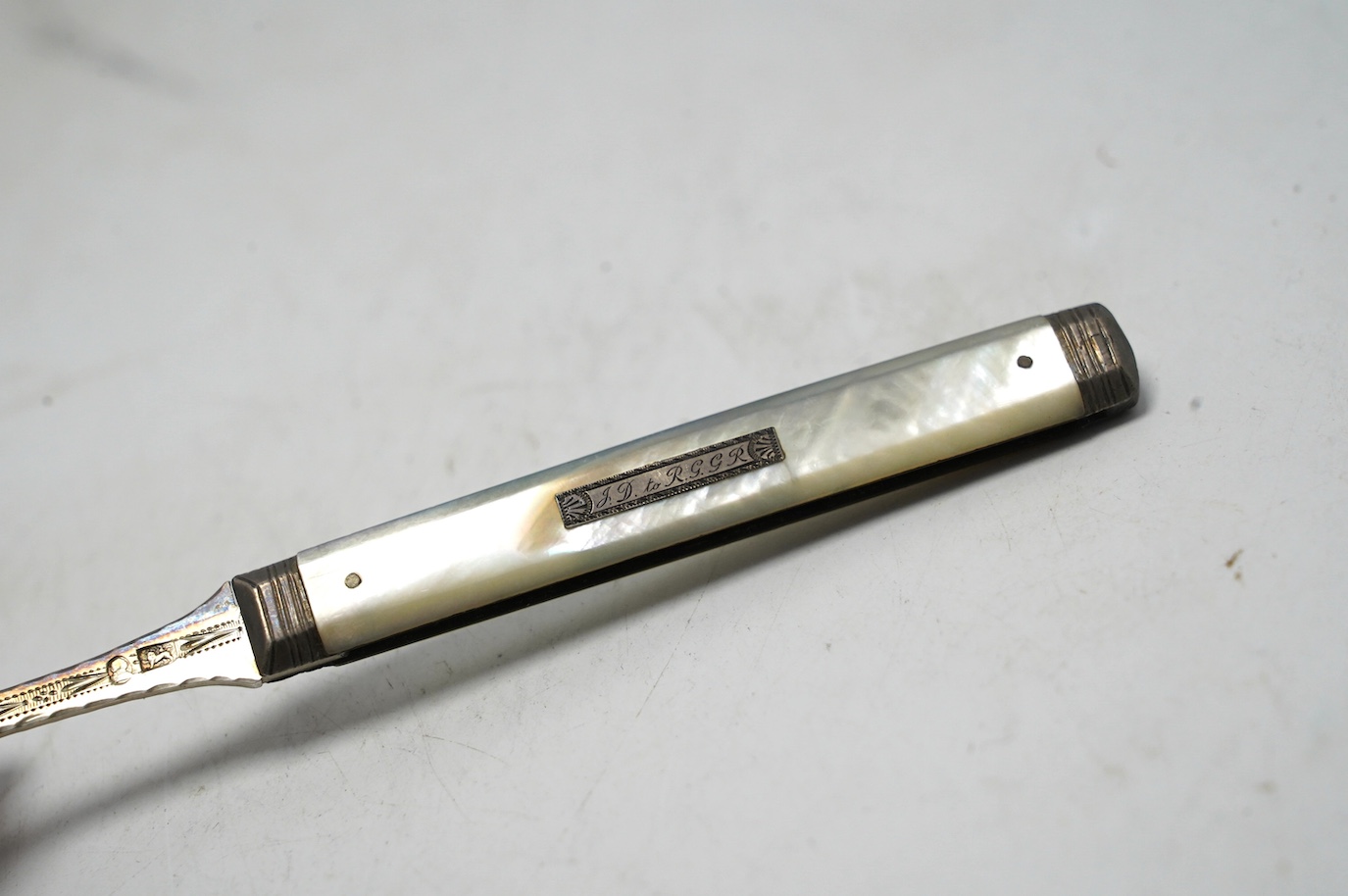 A George III mother of pearl handled silver travelling folding knife and fork, Sheffield, 1816, in original red leather case. Condition - good